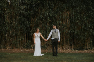 Laura and Will pose in front of the bamboo